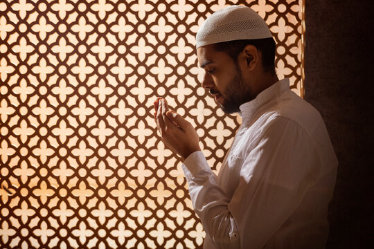Portrait of a Muslim man praying at home