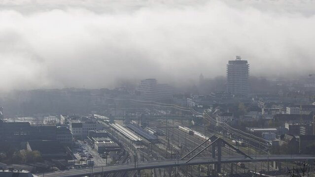 Ulm main station and bridge with low clouds at morning in autumn time lapse