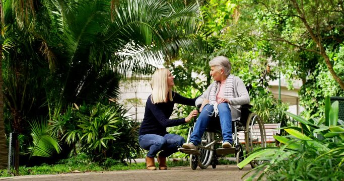 Senior woman, care and wheelchair in park with daughter, family or caregiver outdoor for air, health and wellness. Elderly patient or mother with girl for a walk in nature garden for rehabilitation