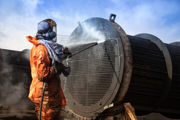 Tube bundle cleaning with high pressure water jetting executed by a worker
