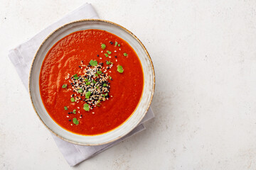 Overhead shot of a bowl full of creamy vegetarian soup served with micro greens, with space for text