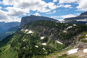 Scenic view of the green slopes in Glacier National Park on a sunny day