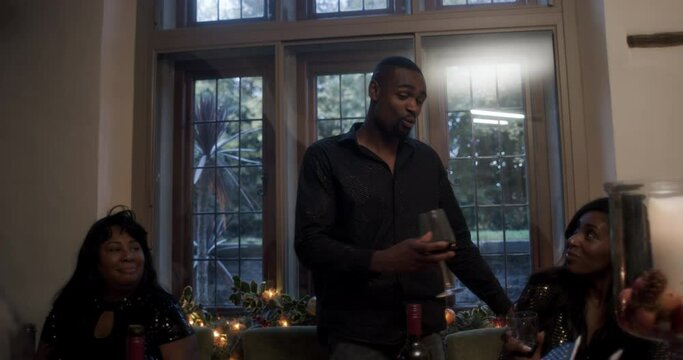 Family toasting with red wine during Thanksgiving dinner at home