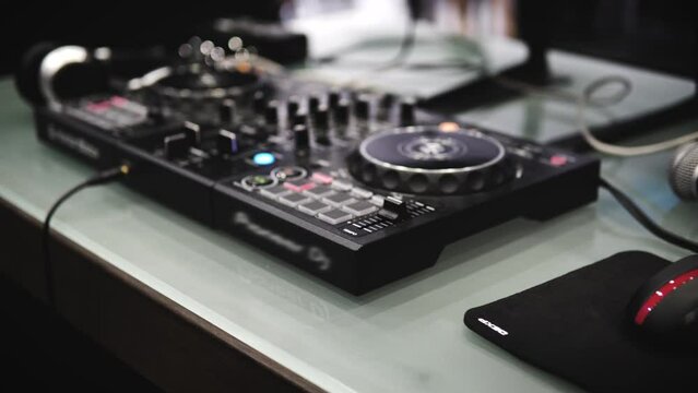 In selective focus Pro dj controller. The DJ console CD mp4 deejay mixing table music party in a nightclub