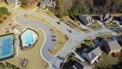 Row of two story new development houses with recreational tennis court and swimming pool in upscale neighborhood suburbs Atlanta, Georgia, USA