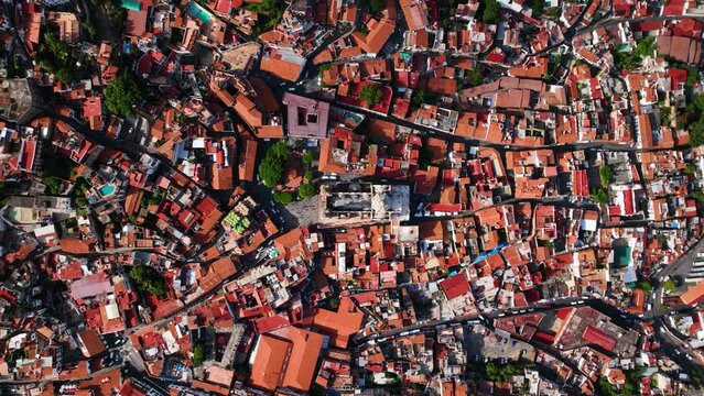 Aerial view above the Church of Santa Prisca de Taxco, in Mexico - birds eye, drone shot