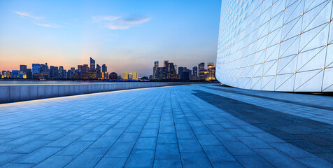Empty floor and modern city skyline with building at night in Hangzhou, China.