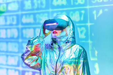 Woman in VR glasses wearing metallic shiny jacket