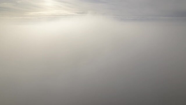 Clouds seen from above with blue sky on horizon time lapse