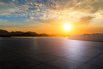 Empty square floor and sea with mountain nature landscape at sunrise 