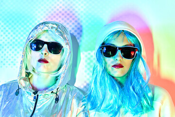 Futuristic women in sunglasses and wigs