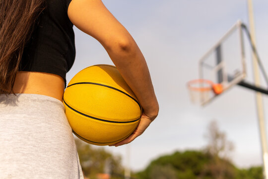 Sportswoman playing basketball on court