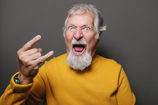 Senior man showing rock gesture