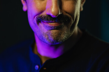 Crop face of man with mustache against black background