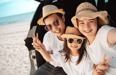 Happy asian family on the beach in holiday. of the family take a selfie.They are having fun playing enjoying on the beach. Summer Family and lifestyle.