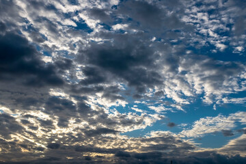 View of blue sky and white clouds colored by sun light