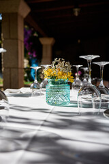 Table set with plates, glasses and flowers, vertical image