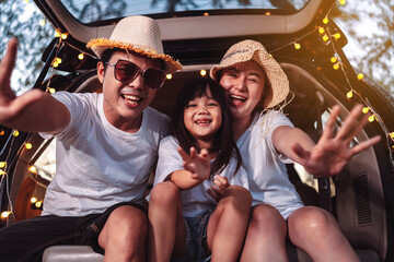 Happy Family with car travel and camping road trip. summer vacation in car in the sunset, Dad, mom and daughter happy traveling enjoy together driving in holidays, people lifestyle ride by automobile.