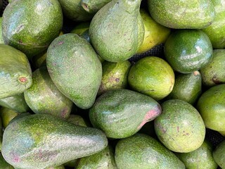 Background of fresh avocados in supermarket ready for sale.