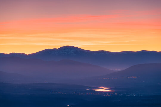 Highland misty valley under sunset sky