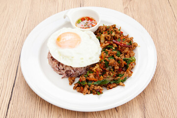 Rice with stir fried minced pork and basil topped with fried egg, Thai food called Pad Ka Prao Moo