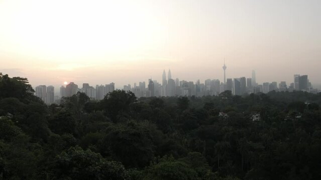 landscape view of kuala lumpur city center downtown district area with many skyscraper building highrise modern style towers with beautiful vanilla sundown sunrise