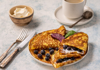 Keto lunch - keto pancakes served with ricotta and blueberries.