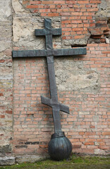 Old church in the Russian city of Volkhov. Restoration is underway now. The metal cross is leaning against the wall.