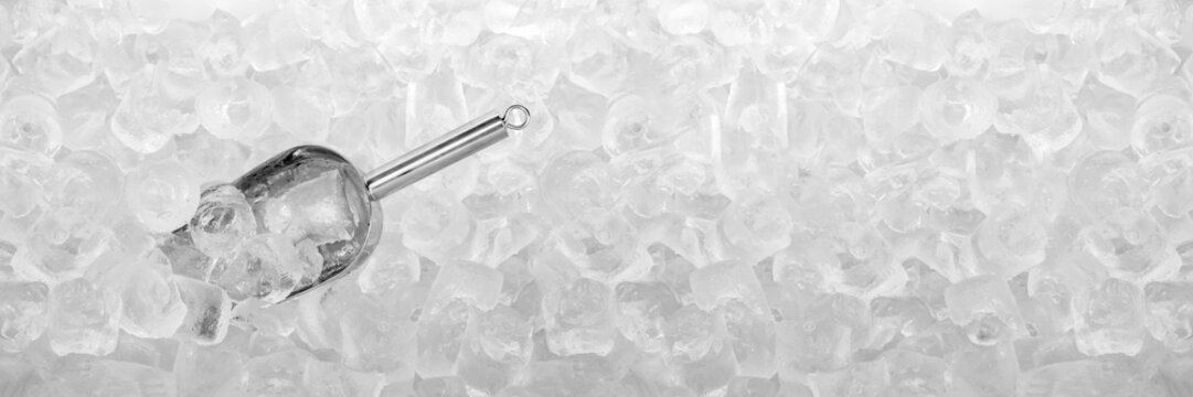 Close up stainless ice scoop with ice cubes in bucket top view use for food and beverage background	
