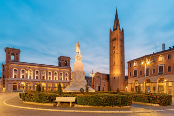 Forlí - The piazza Aurelio Saffi square with the his memorial and Basilica San Mercuriale at dusk.