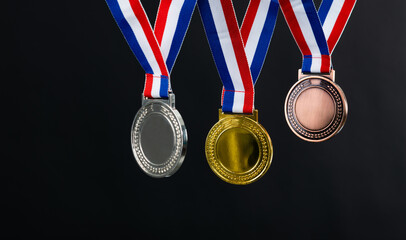 Bronze silver and golden medals on black background