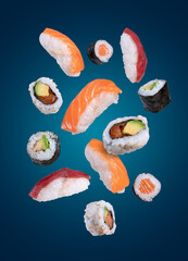 maki sushi flying on dark blue background © Miquel