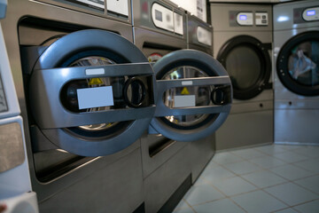 Shared laundry room with several front-loading washing machines