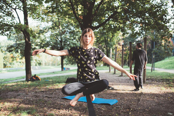 Athletic sportive young woman training acrobatic yoga slacklining