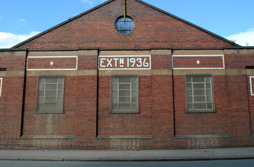 Industrial Brick Building Facade with Ceramic Tiled Signage 