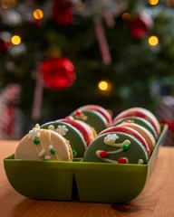 Foto op Canvas Vertical view of colorful macarons in the box on a wooden surface - Holidays sweets © Pjm Captures/Wirestock Creators