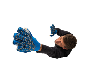 Soccer goalkeeper jumps to defend his team during a football game