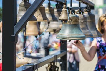Close-up of small church bells on the street. Religion.