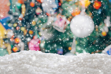 Fototapeta na wymiar Empty white snow with blur Christmas tree with bokeh light background