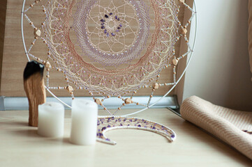 Interior dreamcatcher mandala with amethyst and candles, incense, spiritual ritual