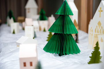 Christmas composition with decorative playhouses and paper trees. Christmas installation.