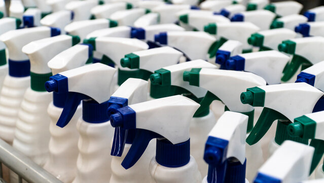 sprayer bottle. Group of white sprayer bottles high angle view. Cleaning equipments concept. Selective focus included