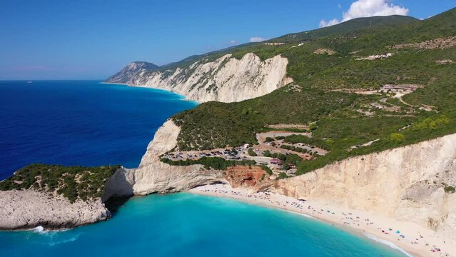 Aerial drone video of popular paradise deep turquoise beach of Porto Katsiki with white steep rocky seascape and beautiful cloudy landscape, Lefkada island, Ionian, Greece