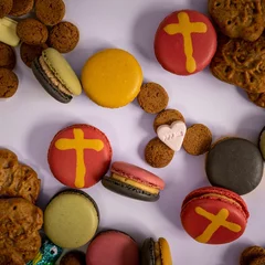 Keuken spatwand met foto Top view of cookies and French macarons with cross design - Holiday sweets © Pjm Captures/Wirestock Creators