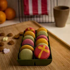 Keuken spatwand met foto Colorful French macarons in a box over the wooden surface - Holiday sweets © Pjm Captures/Wirestock Creators