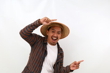 Happy asian farmer standing while pointing something beside him. Isolated on white background