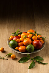 A large plate of fruits on a wooden table