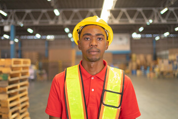Portrait of black worker working in large warehouse retail store industry. Rack of stock storage. Interior of cargo in ecommerce and logistic concept. Depot. People lifestyle. Shipment service.