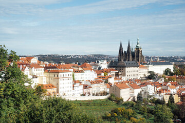Obraz premium Prague, Czech Republic, a fairy tale with orange-roofed houses and Prague Castle in harmony with nature