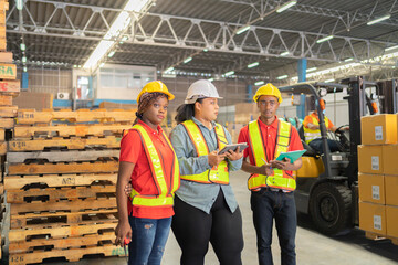 Teamwork of black workers and fat woman working in large warehouse retail store industry. Rack of...